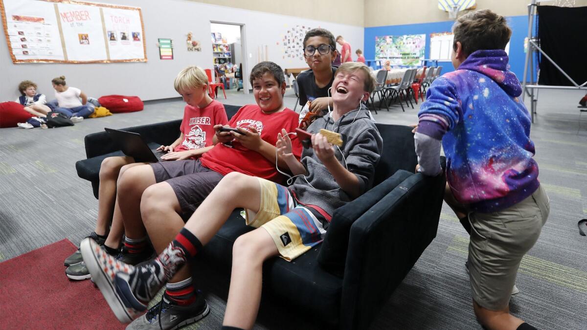 Kids play video games in the Teen Center at the Boys & Girls Club of Costa Mesa, which is set to get a $2-million renovation as part of a larger initiative in the Boys & Girls Clubs of Central Orange Coast.