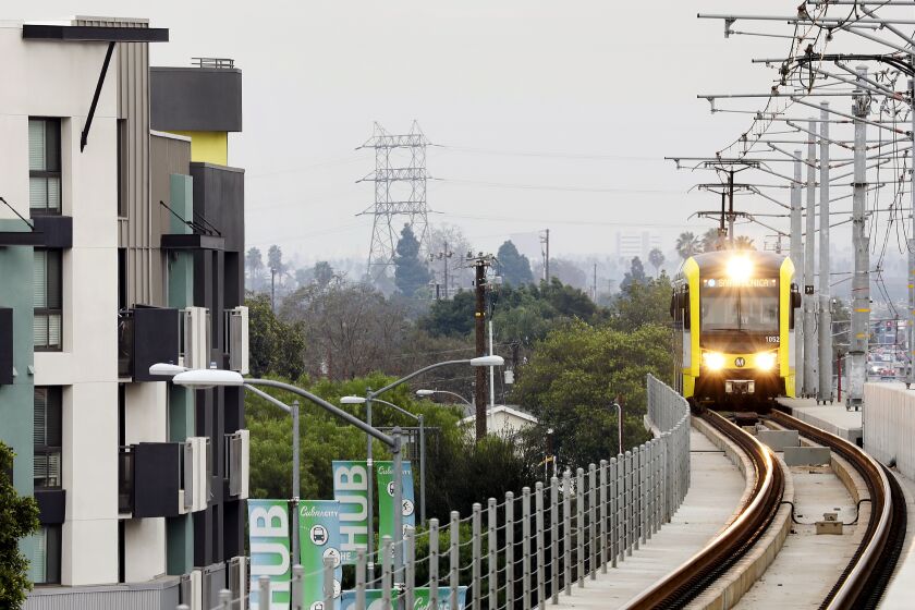 A Metro train passes by apartments in Culver City in 2017. 