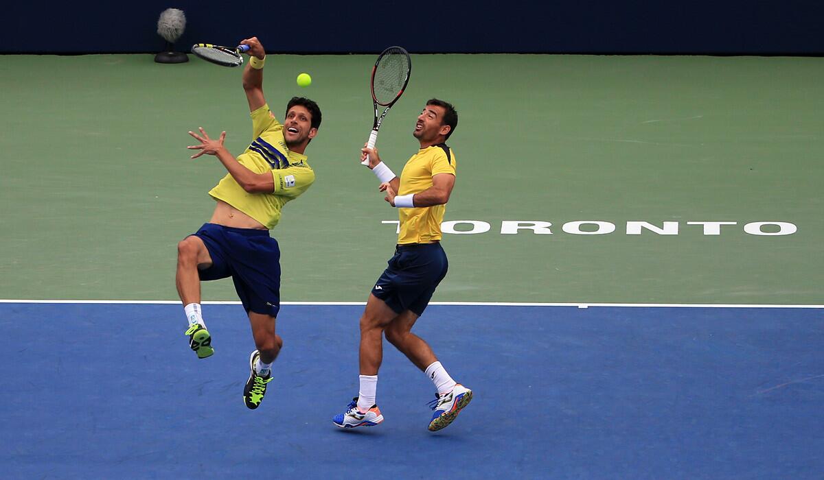Marcelo Melo, left, and Ivan Dodig play a shot in the doubles final against Jamie Murray and Bruno Soares in the Rogers Cup on Sunday.