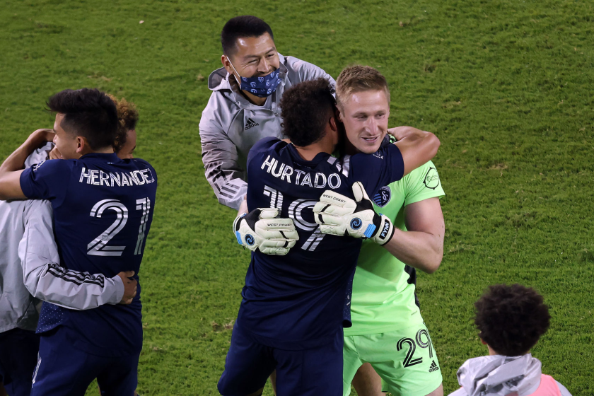 Sporting Kansas City players rush to congratulate goalkeeper Tim Melia.