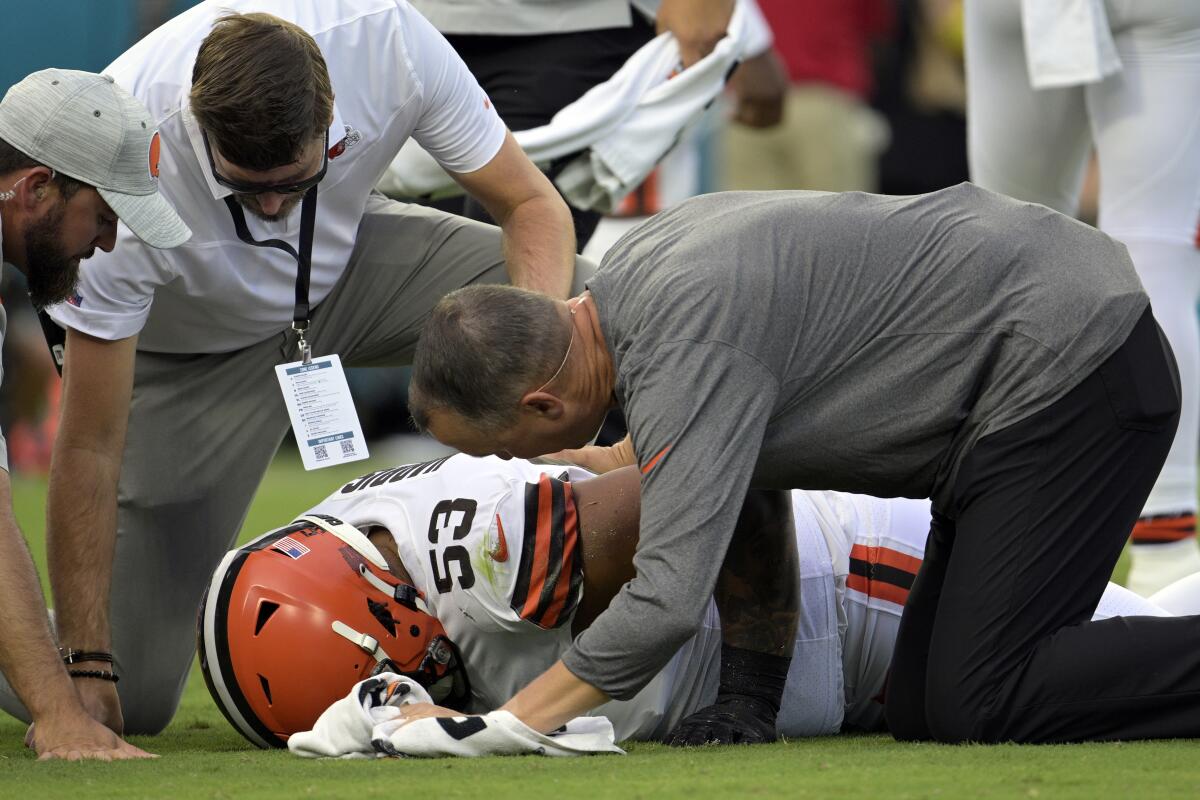 FILE - Cleveland Browns personnel check on Cleveland Browns center Nick Harris (53) after he was injured during the first half of an NFL preseason football game against the Jacksonville Jaguars, Friday, Aug. 12, 2022, in Jacksonville, Fla. (AP Photo/Phelan M. Ebenhack, File)