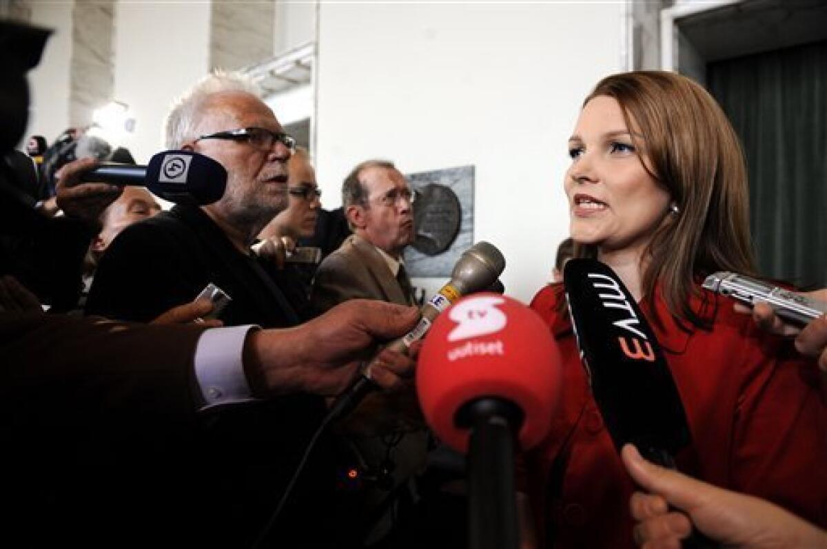 Finland's new Prime Minister Mari Kiviniemi, of the Center Party, is surrounded by the media after voting at the Parliament in Helsinki, Finland Tuesday June 22, 2010. (AP Photo/Lehtikuva/Mikko Stig)