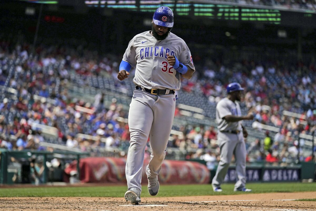 Chicago Cubs' Franmil Reyes scores the go ahead run on a single by Yan Gomes during the seventh inning of a baseball game against the Washington Nationals at Nationals Park Wednesday, Aug. 17, 2022, in Washington. The Cubs won 3-2. (AP Photo/Andrew Harnik)