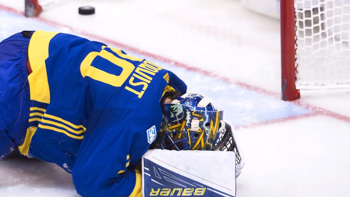 Sweden goalie Henrik Lundqvist reacts after giving up a goal to Team Europe in overtime Sunday.