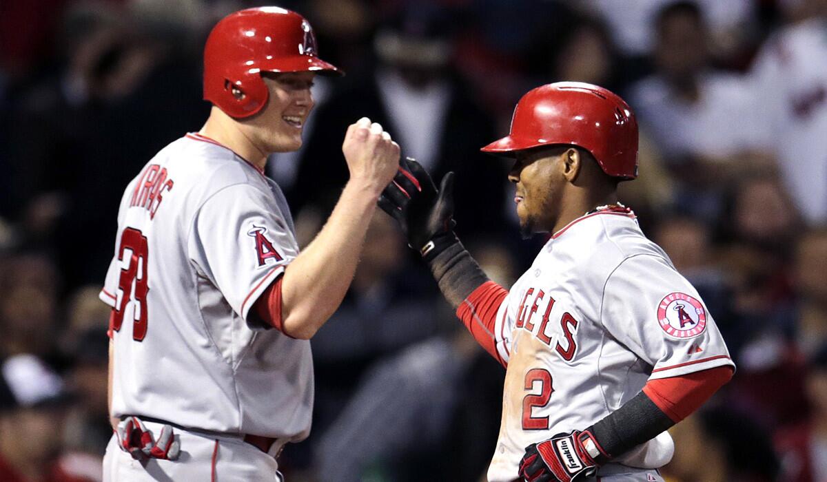 Los Angeles Angels' Erick Aybar is congratulated by teammate Marc Krauss after his two-run home run during a 12-5 win against the Boston Red Sox on Friday.