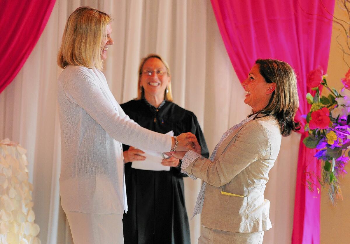 Julie Engbloom, left, and Laurie Brown are married by Judge Beth A. Allen in Portland. "The biggest question was, 'Oh, my God, what to wear?'" Engbloom said.