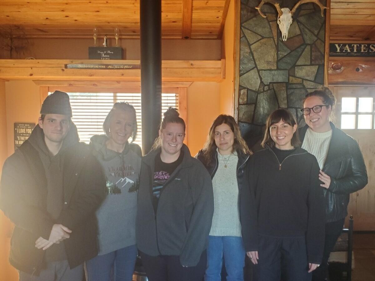 Group of podcast producers standing in a home in Montana