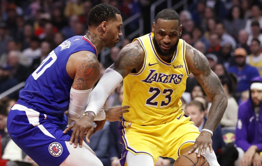 Lakers forward LeBron James spins to the basket against Clippers forward Mike Scott in the second quarter on Jan. 31 at Staples Center. 