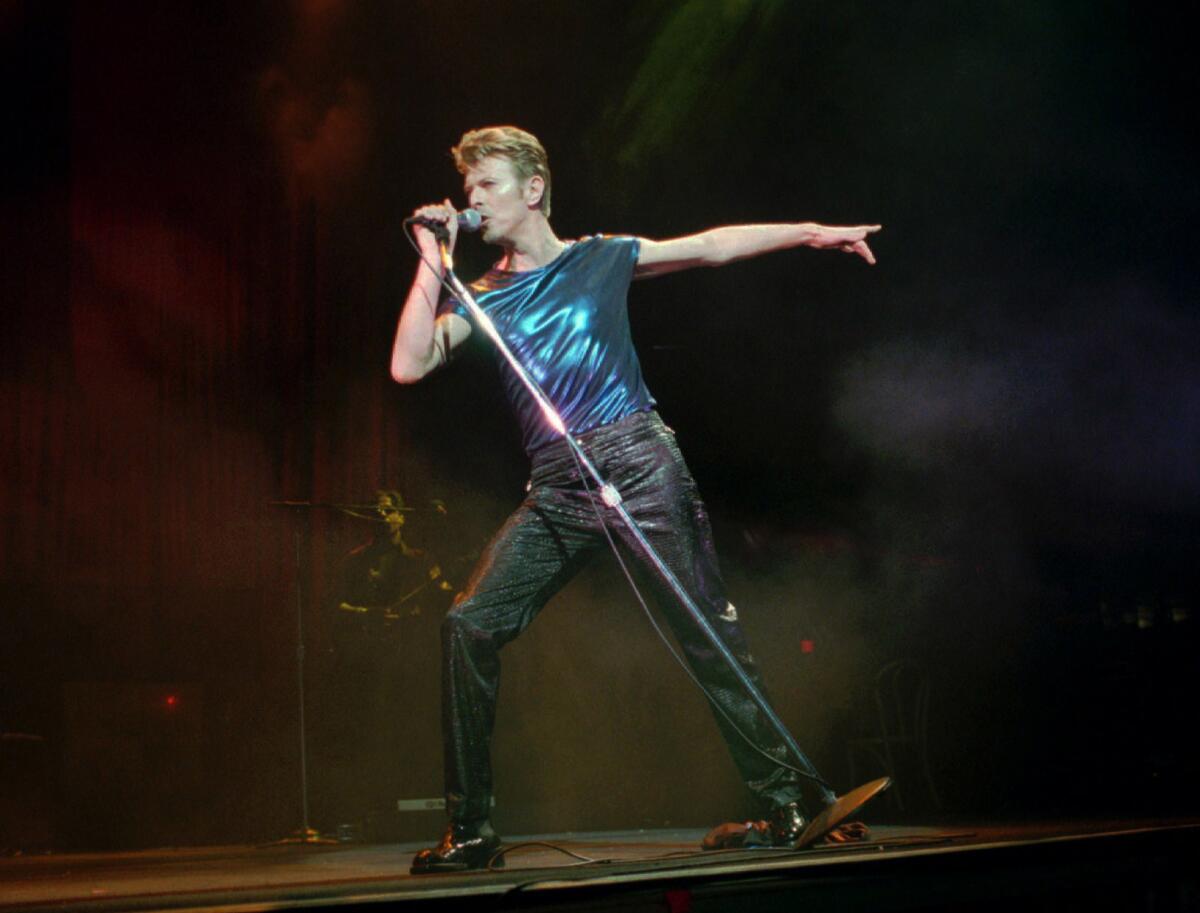 In this Sept. 14, 1995, file photo, David Bowie performs in Hartford, Conn.