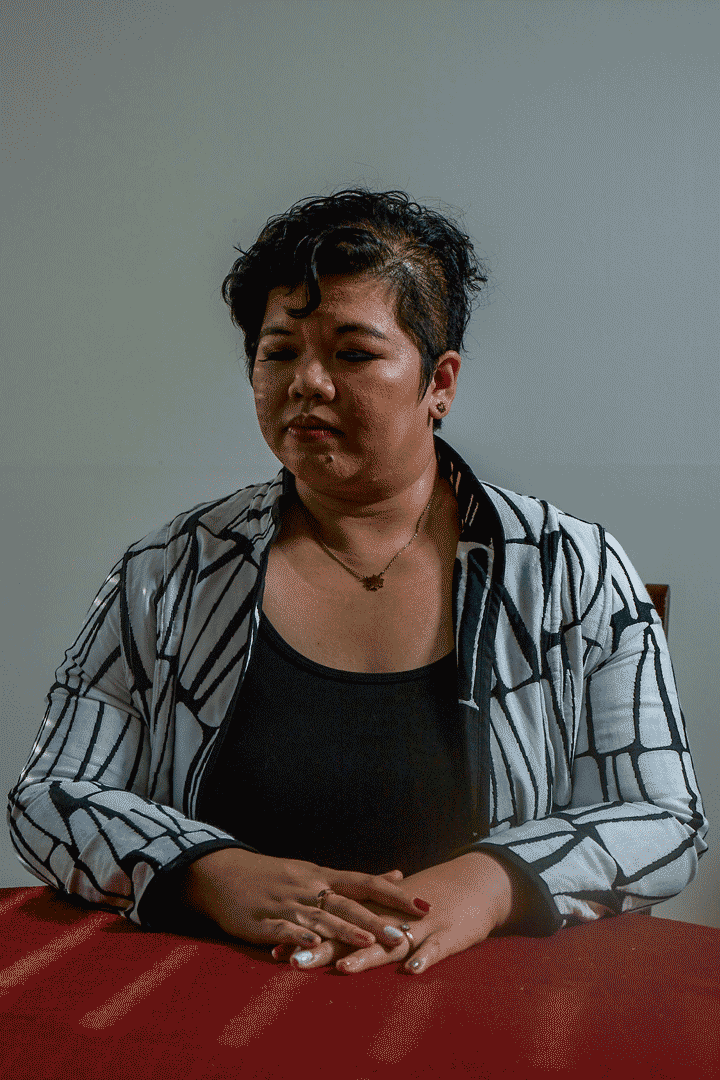 An animated gif of a woman sitting at a red table