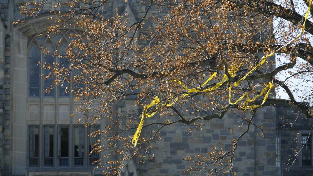 Police tape hangs in the trees in front of Norris Hall on the campus of Virginia Tech Monday, April 16, 2007, in Blacksburg, Va. A gunman opened fire in a Virginia Tech dorm and then, two hours later, in a classroom across campus Monday, killing at least 30 people. Most of the victims were killed inside Norris Hall. (AP Photo/Casey Templeton) ORG XMIT: VACA104
