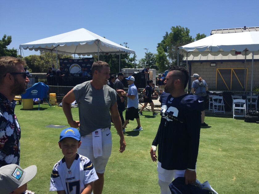 Chargers quarterback Philip Rivers, left,  talks to former teammate, Rams safety Eric Weddle, after the teams' joint practice.