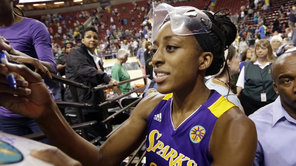 Sparks forward Nneka Ogwumike signs a autograph for a fan following the team's win over the Seattle Storm on Thursday.