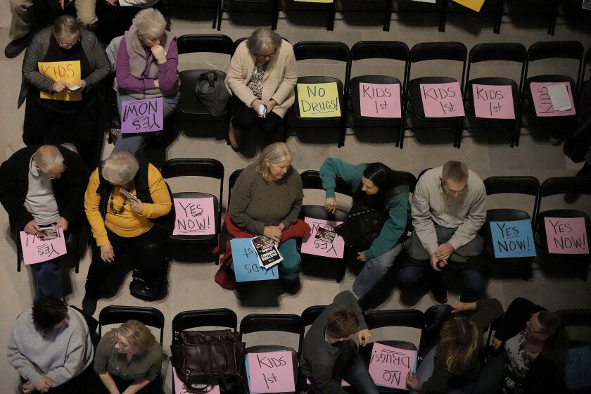 People wait for the start of a rally in favor of legislation banning gender-affirming healthcare for minors, Monday, March 20, 2023, at the Missouri Statehouse in Jefferson City, Mo. (AP Photo/Charlie Riedel)