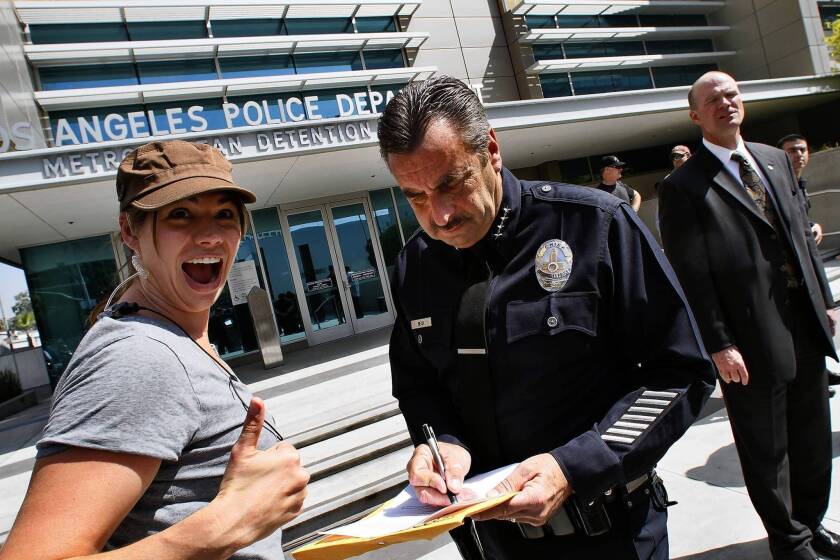 Katey Wheelhouse, left, second assistant diector of the TNT police drama "Southland," is shown with LAPD Chief Charlie Beck during filming of the show's season finale in front of Parker Center in Los Angeles.