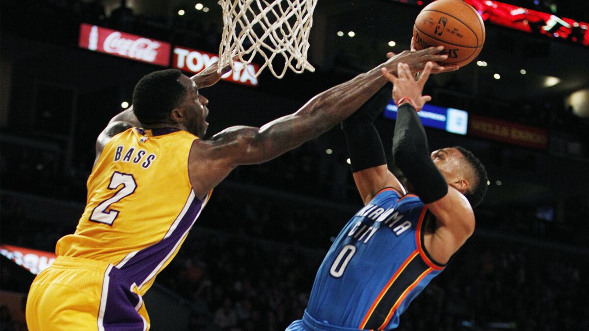 Lakers forward Brandon Bass (2) blocks a shot by Thunder guard Russell Westbrook (0) in the second half.