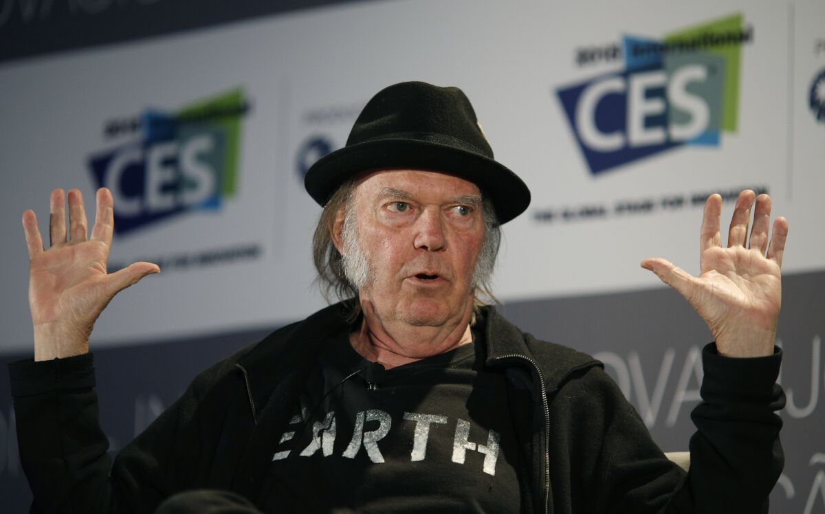 Neil Young, shown at the 2015 Consumer Electronics Show in Las Vegas, became a U.S. citizen in January and blasted President Trump in an open letter on Tuesday, Feb. 18.