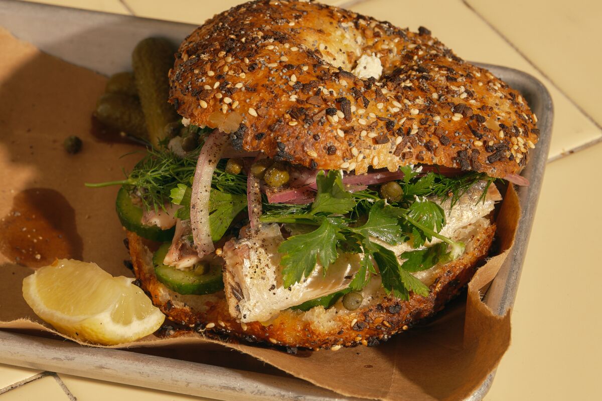 A piled-high sandwich on an everything bagel.