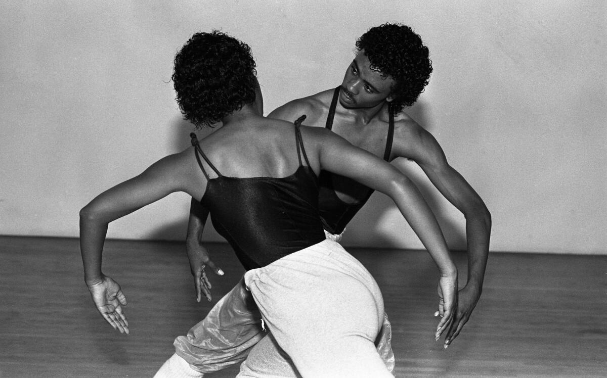 Two dancers practice choreography in 1982.