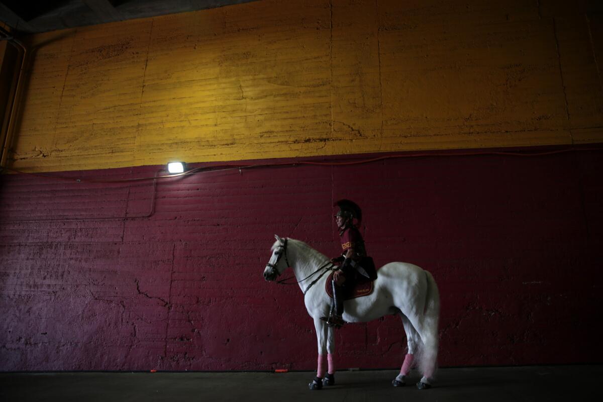 Hector Aguilar sits atop Traveler moments before the USC Trojans and Colorado Buffaloes play at the Coliseum on Oct. 18, 2014.