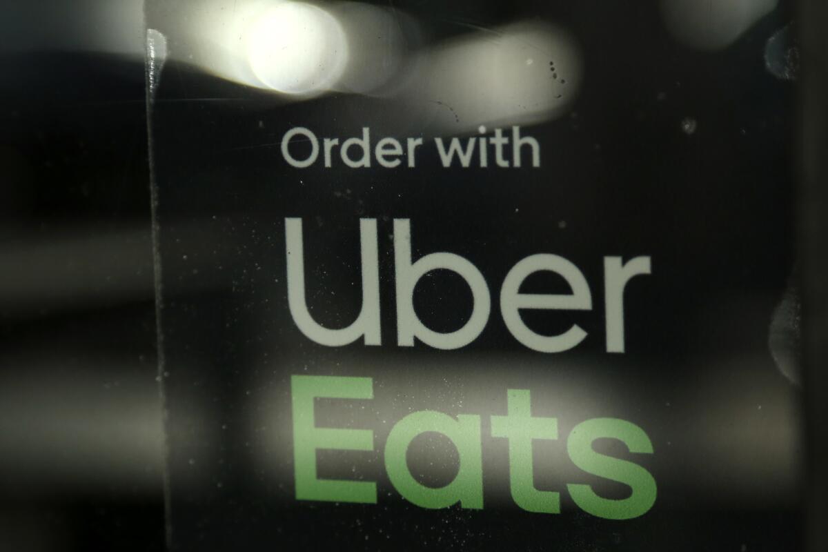A Miami restaurant sign advertises Uber Eats in 2019.