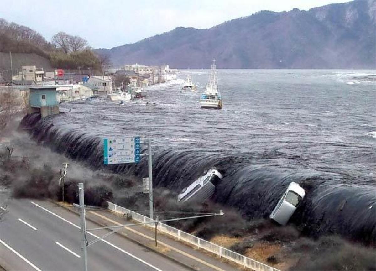 A tsunami wave breaches an embankment in the city of Miyako, Japan, on March 11.