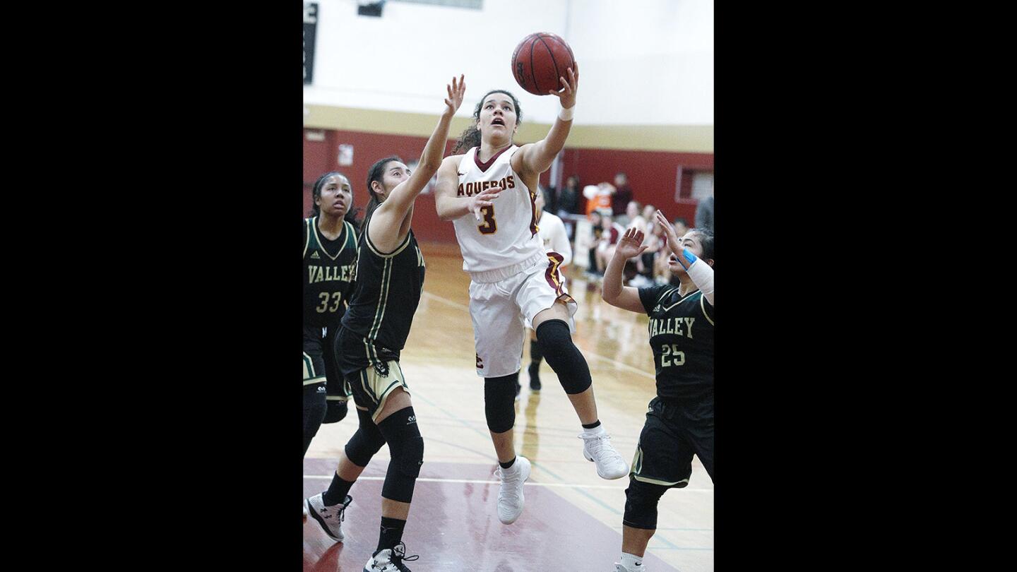 Glendale Community College's Cheyenne Jankulovski drives to the basket to shoot against LA Valley College's Zoila Ileya Rivera in a Western State Conference women's basketball game at Glendale Community College in Glendale on Wednesday, January 24, 2018. GCC lost to LA Valley College 50-41.
