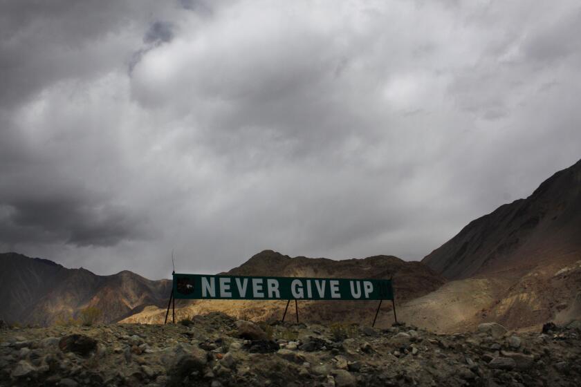 In this Sept. 14, 2017, file photo, a banner erected by the Indian army stands near Pangong Tso lake near the India-China border in India's Ladakh area. As the escalating and bitter military standoff between India and China protracts following their bloodiest confrontation in decades in the Ladakh region in 2020, experts warn the two nuclear-armed countries can unintentionally slide into a war over the roof of the world. The two most populous nations share thousands of kilometers (miles) disputed border and have accused each other for opening new fronts. (AP Photo/Manish Swarup, File)