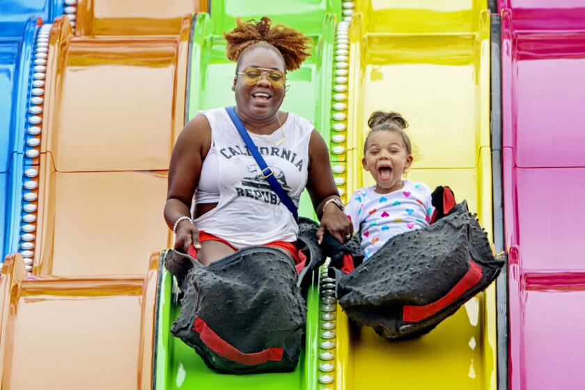 SAN DIEGO, CA-ULY 1: Fabeann and her daughter Sloane,5, Sobergat enjoy the slide ride at the San Diego County Fair on Saturday, July 1, 2023 in Del Mar.(Photo by Sandy Huffaker for The SD Union-Tribune)