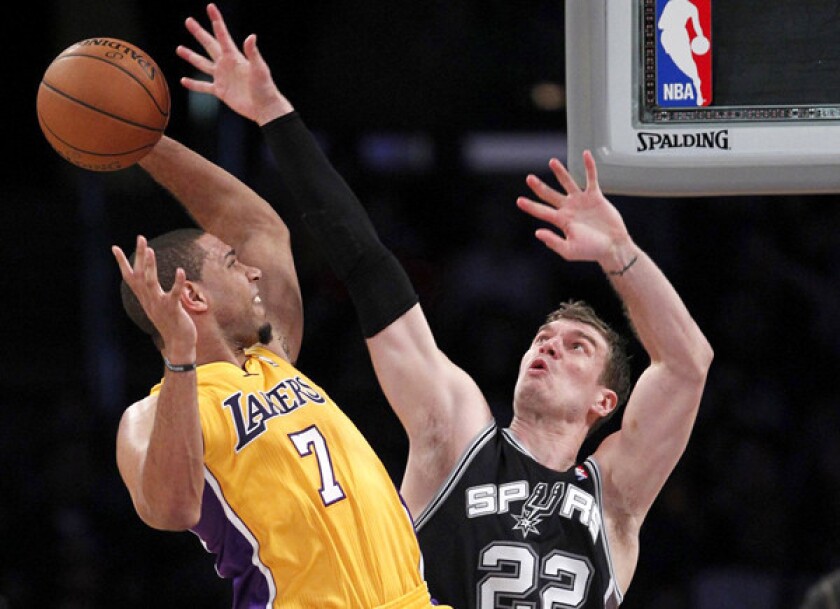 Spurs center Tiago Splitter looks to block a shot by Lakers forward Xaiver Henry in the first half Wednesday night at Staples Center.