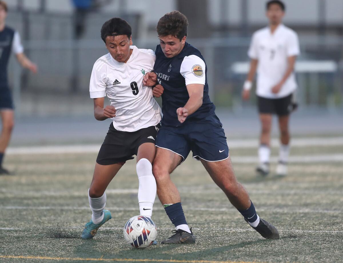 Newport Harbor's Eduardo Hopkin, right, bumps Oxnard Pacifica's Jesus Soto (4) off the ball on Tuesday.