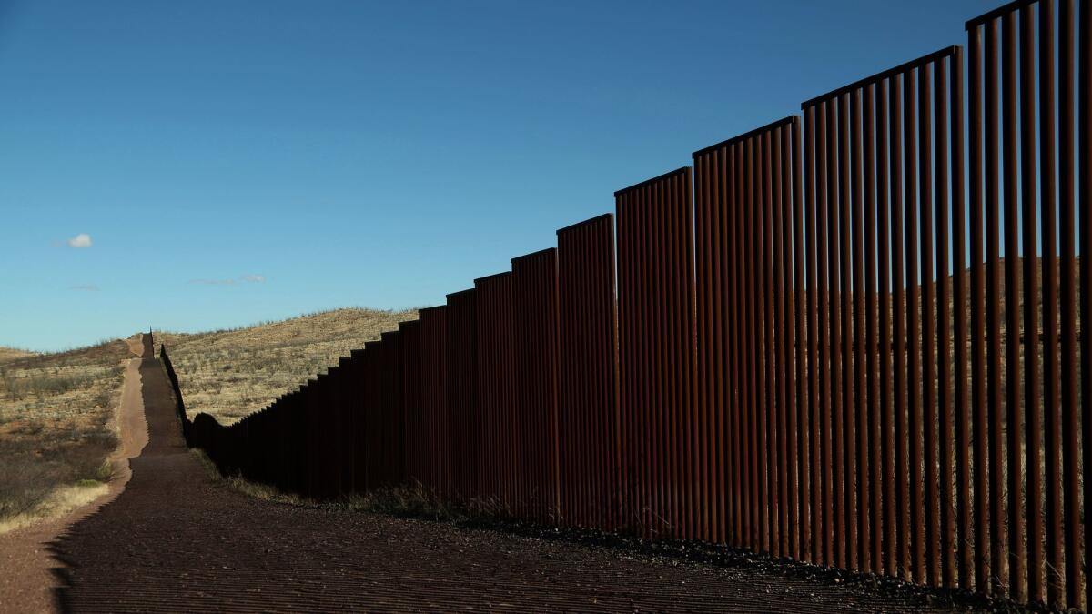 Along the border fence of the United States, left of the fence, and Mexico, on the right, just south of Bisbee in rural Cochise County, Arizona on January 25th. (Los Angeles Times)