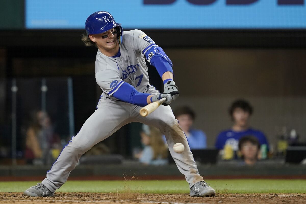 Kansas City Royals' Bobby Witt Jr. connects for a fielders choice in the seventh inning of a baseball game against the Kansas City Royals, Wednesday, May 11, 2022, in Arlington, Texas. Witt Jr., was safe at first and Whit Merrifield scored on the play. (AP Photo/Tony Gutierrez)