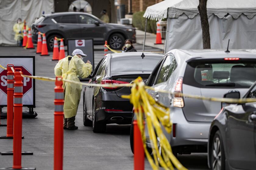 YORBA LINDA, CA - MARCH 19, 2020: Drivers wait in line at a drive-thru coronavirus testing place at St. Jude Heritage Medical Group on March 19, 2020 in Yorba Linda, California. (Gina Ferazzi/Los AngelesTimes)