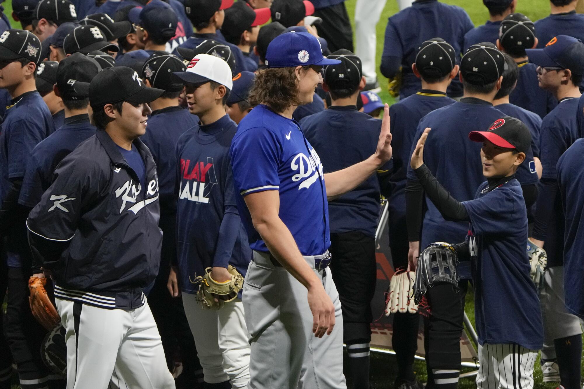 Tyler Glasnow, center, is greeted by a young fan during a skills clinic at Gocheok Sky Dome in Seoul on March 16.