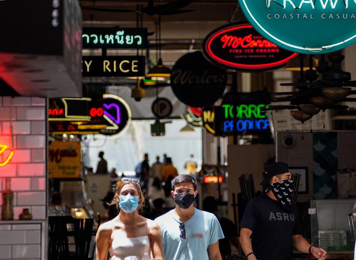 People wearing masks in downtown Los Angeles at Grand Central Market.