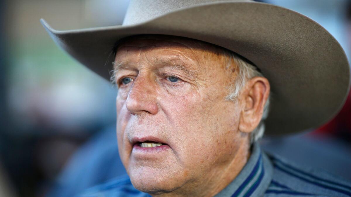 In this April 11, 2015 photo, Nevada rancher Cliven Bundy speaks with supporters at an event in Bunkerville, Nev.