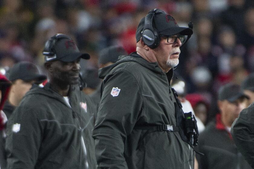 Tampa Bay Buccaneers head coach Bruce Arians and defensive coordinator Todd Bowles coaching at an NFL game.