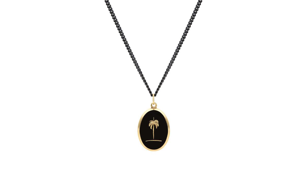 Miansai 14-karat yellow gold plated sterling silver and black enamel palm tree necklace on 24-inch chain, $164 at Miansai in Venice, miansai.com.