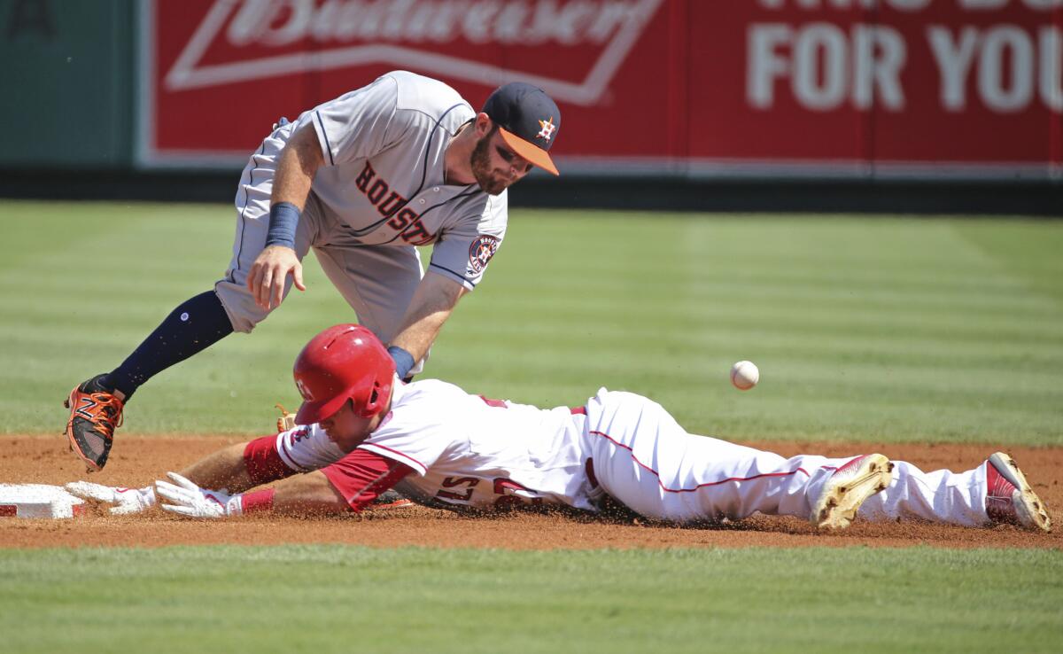 Astros second baseman Tyler White loses the ball as Angels outfielder Mike Trout steals his 30th base on the season.