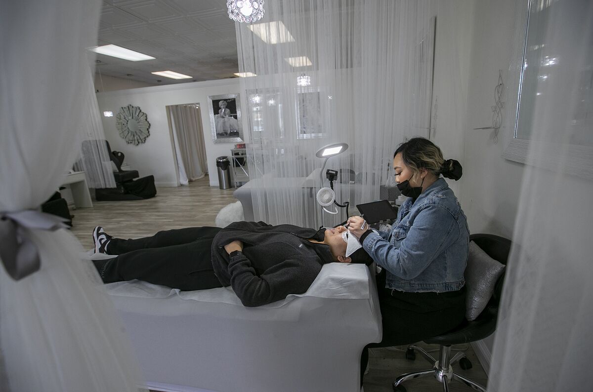 Wynter Ho works at her salon "Wink By Wynter" in Huntington Beach.