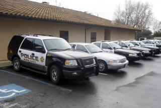 Patrol cars are lined up at the King City Police Deptment on Wednesday, Feb. 26, 2014, in King City, Calif. The acting police chief and two officers in King City were removed from duty after being arrested on suspicion of selling or giving away the impounded cars of poor residents, authorities said. (AP Photo/Marcio Jose Sanchez)