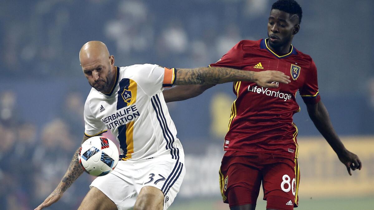 Galaxy defender Jelle Van Damme, left, protects the ball from Real Salt Lake forward Olmes Garcia during their MLS playoff game on Oct. 26.