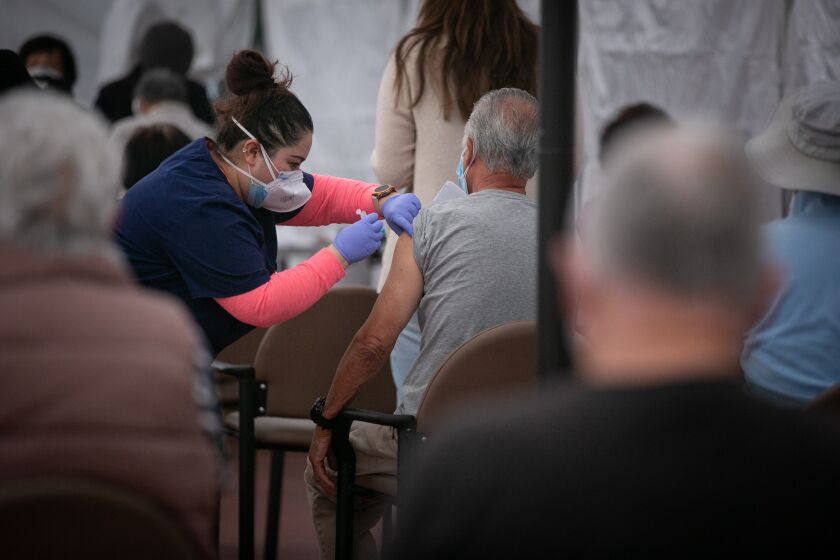 LOS ANGELES, CA - FEBRUARY 11: A nurse administers the COVID-19 vaccine at Kedren Health on Thursday, Feb. 11, 2021 in Los Angeles, CA. (Jason Armond / Los Angeles Times)