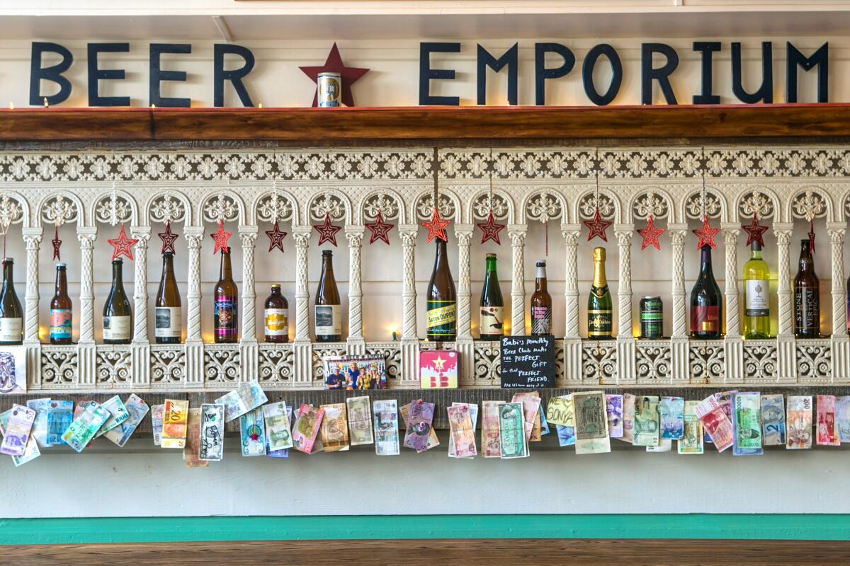 Bottles of beer are shown in a decorative display under a sign that says "Beer Emporium."