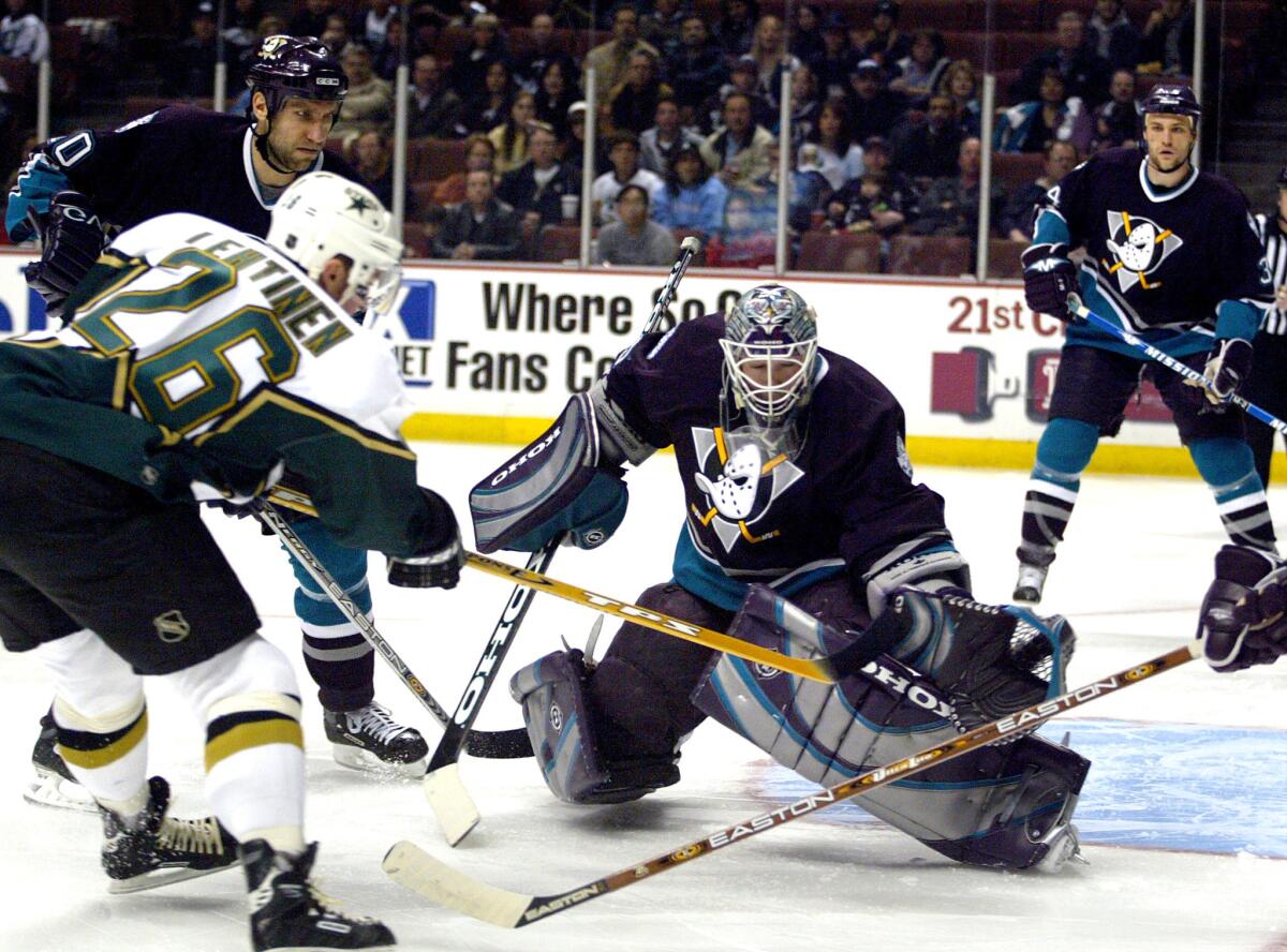 Mighty Ducks' goalie Jean–Sebastien Giguere (35) makes the stop on a shot by Jere Lehtinen (26) of the Stars (left) in the first period at the Pond in 2003.