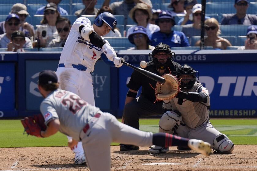 Los Angeles Dodgers' Shohei Ohtani, second from left, hits a solo home run.