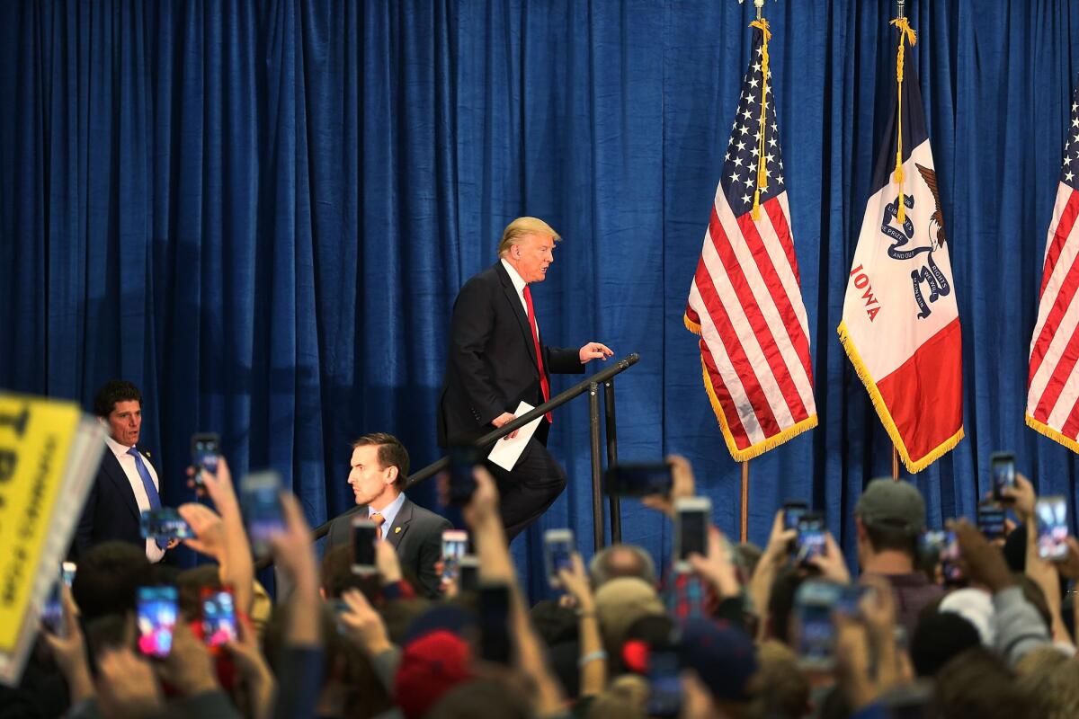 Republican presidential candidate Donald Trump walks onto the stage during a campaign event at the University of Iowa on Tuesday in Iowa City.