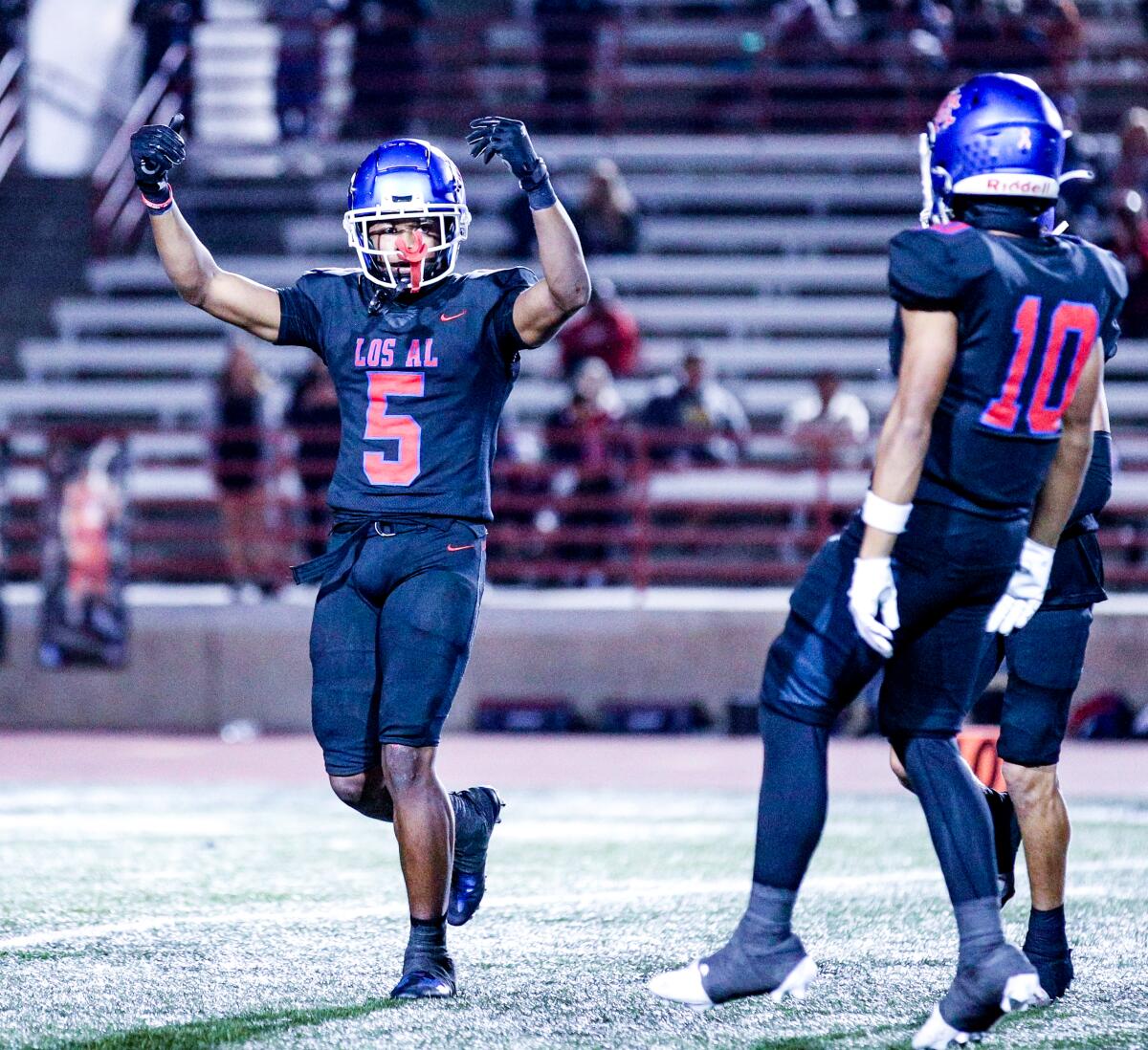 Let the playoffs begin. Isaiah Rubin (5) of Los Alamitos is excited after interception against Edison.