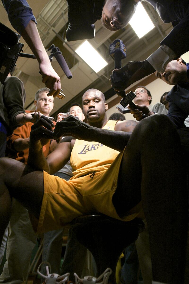 Shaquille O'Neal is surrounded as he answers questions following practice ahead of game 2 of the 2004 NBA Western Conference finals.
